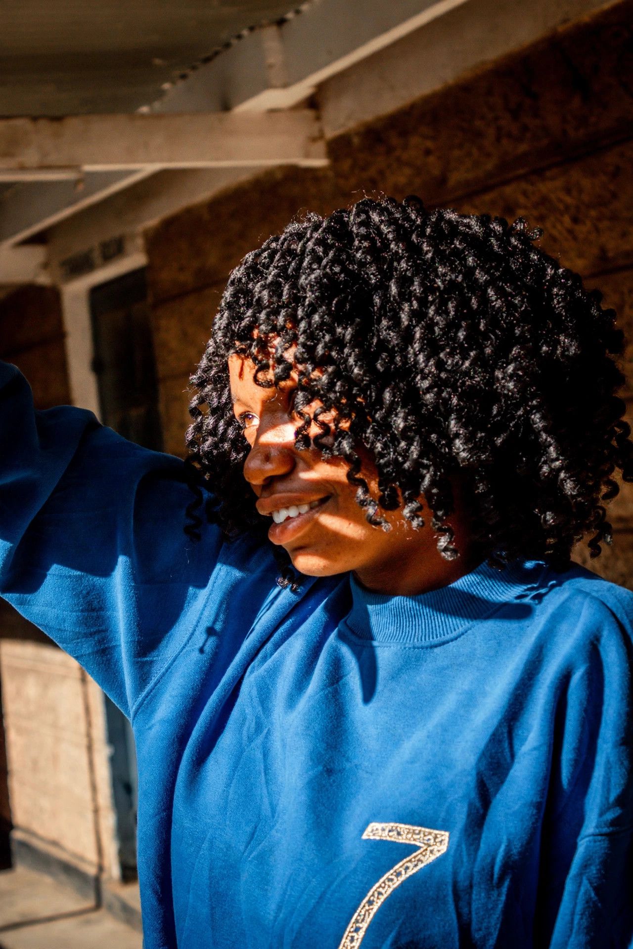 Portrait of a Black woman with defined coils
